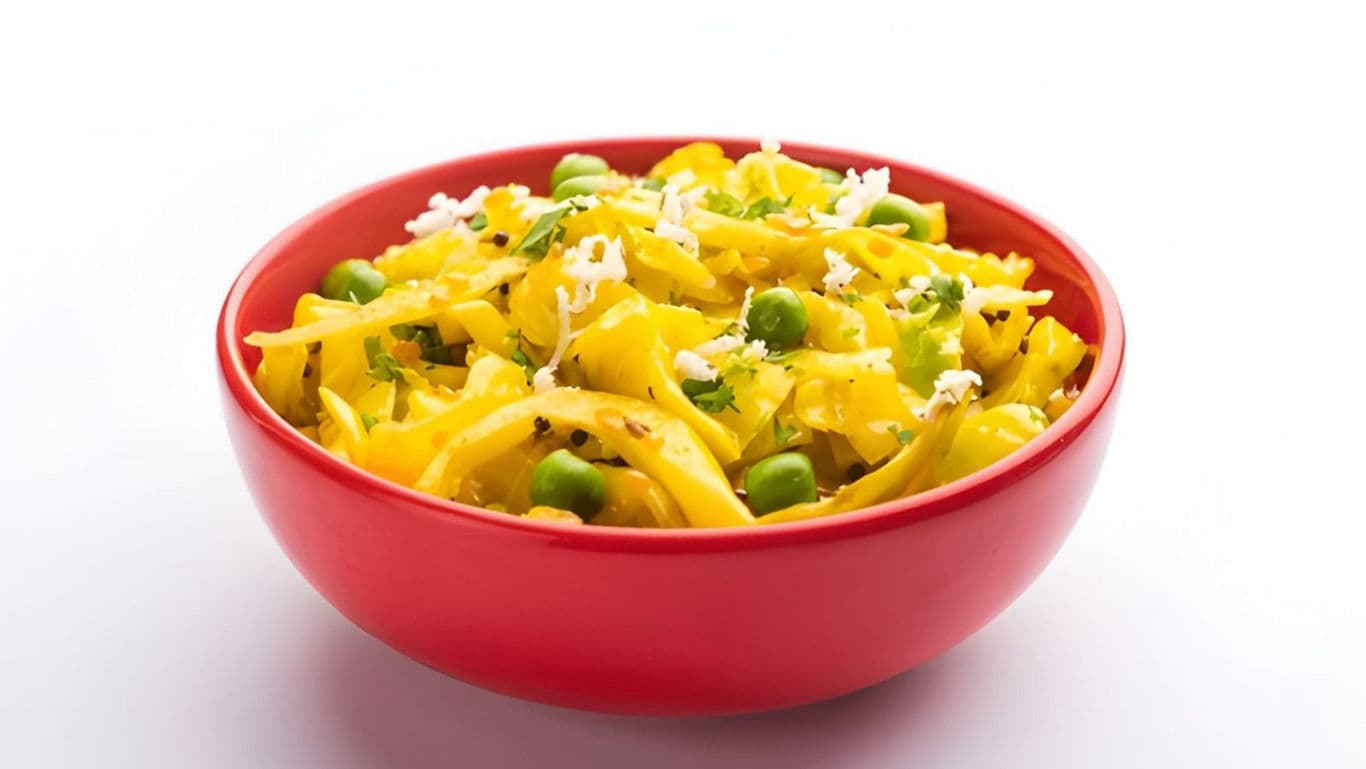 Yellow pasta with peas in red bowl