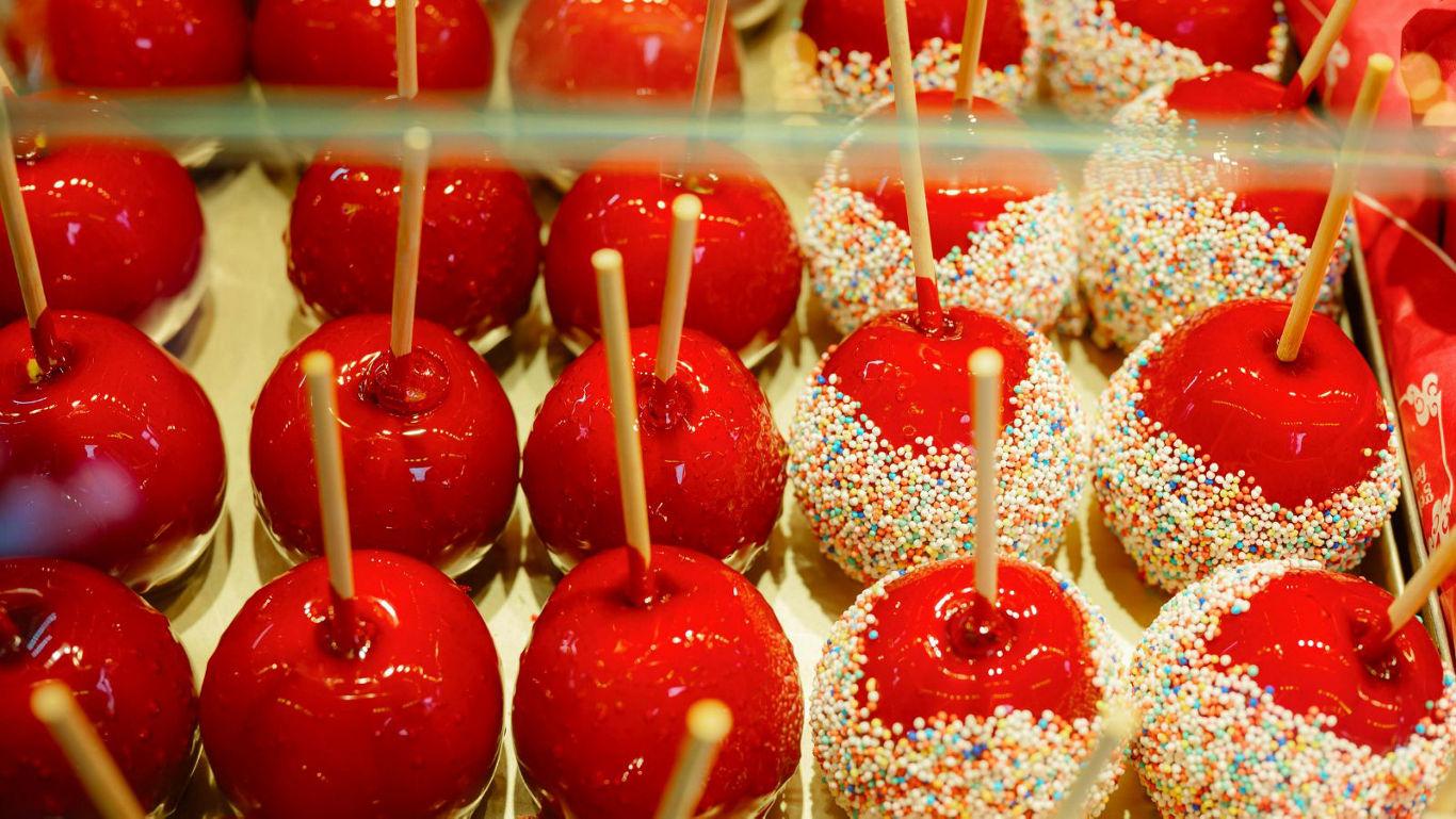 Red candy apples with sprinkles display