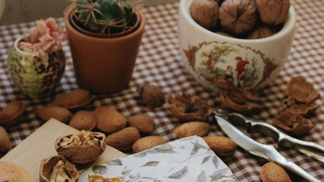 Rustic table with nuts and kitchen tools
