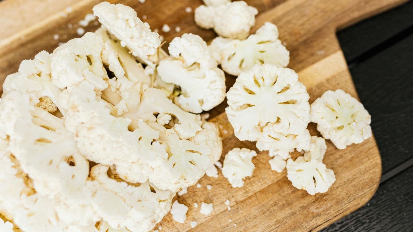 Fresh Cauliflower Florets on Wooden Board