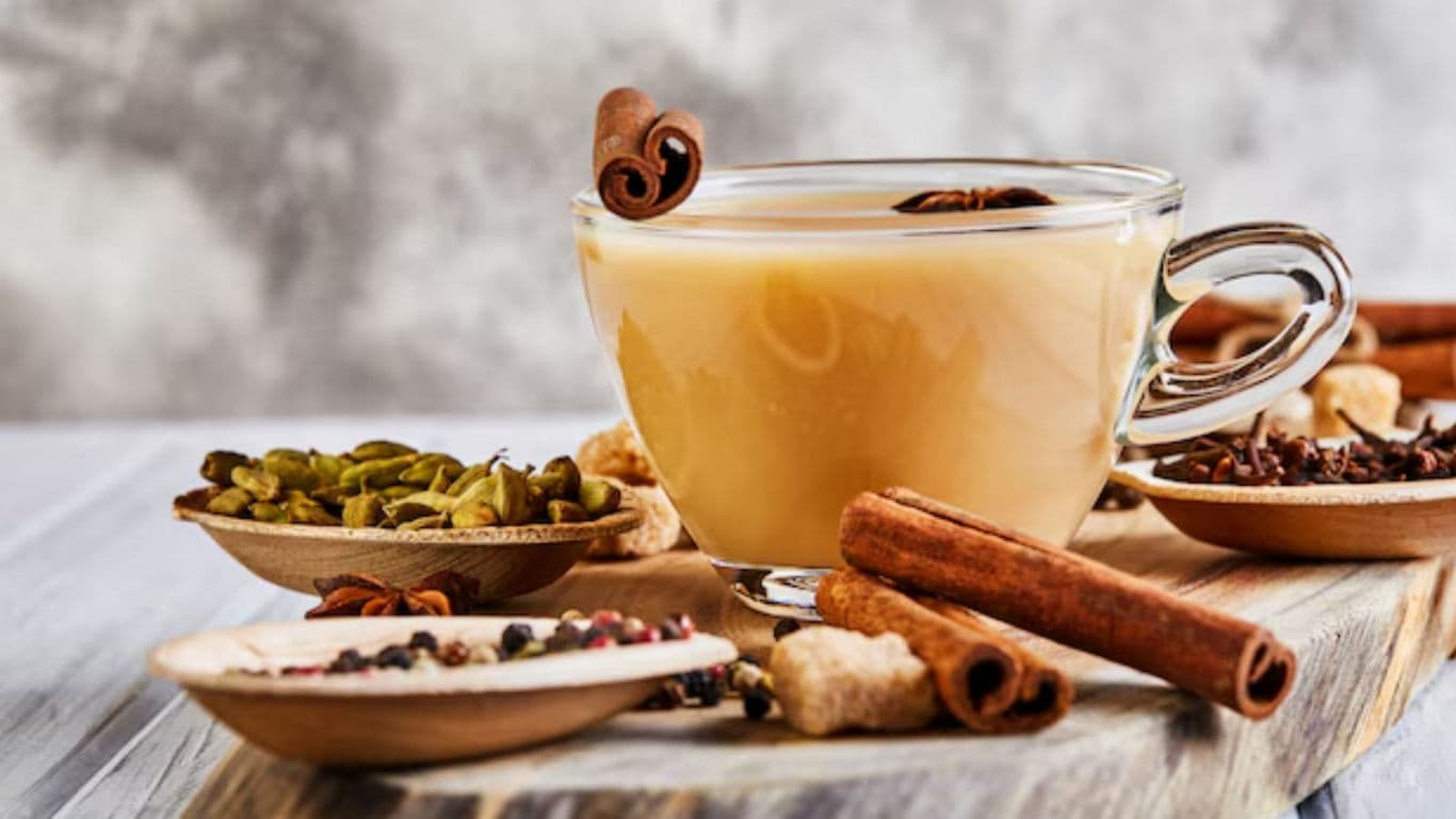 Glass cup of chai tea with assorted spices