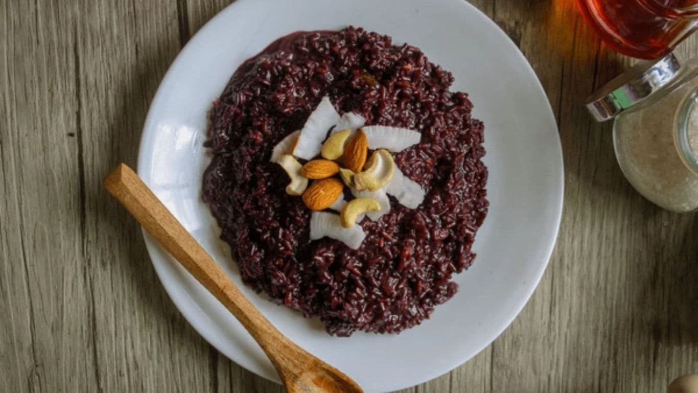 Black rice pudding with nuts and coconut flakes