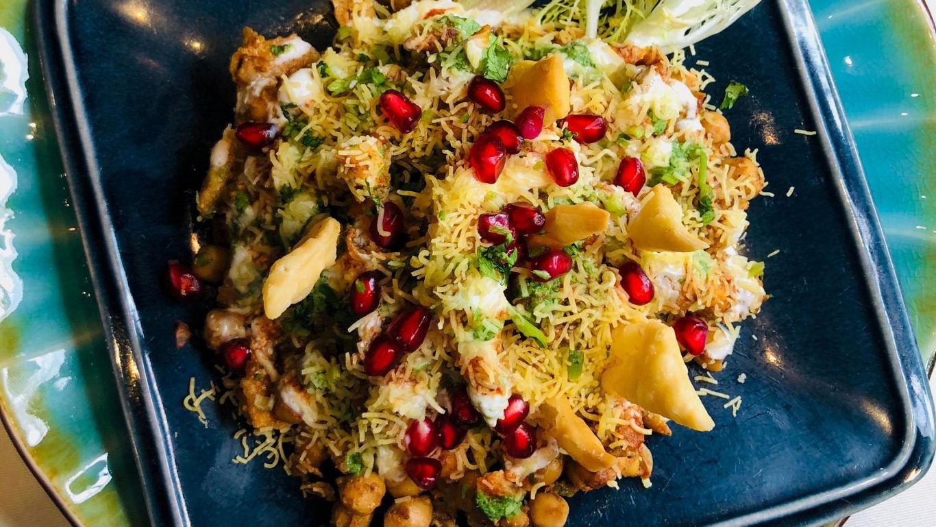Colorful Indian chaat with pomegranate garnish
