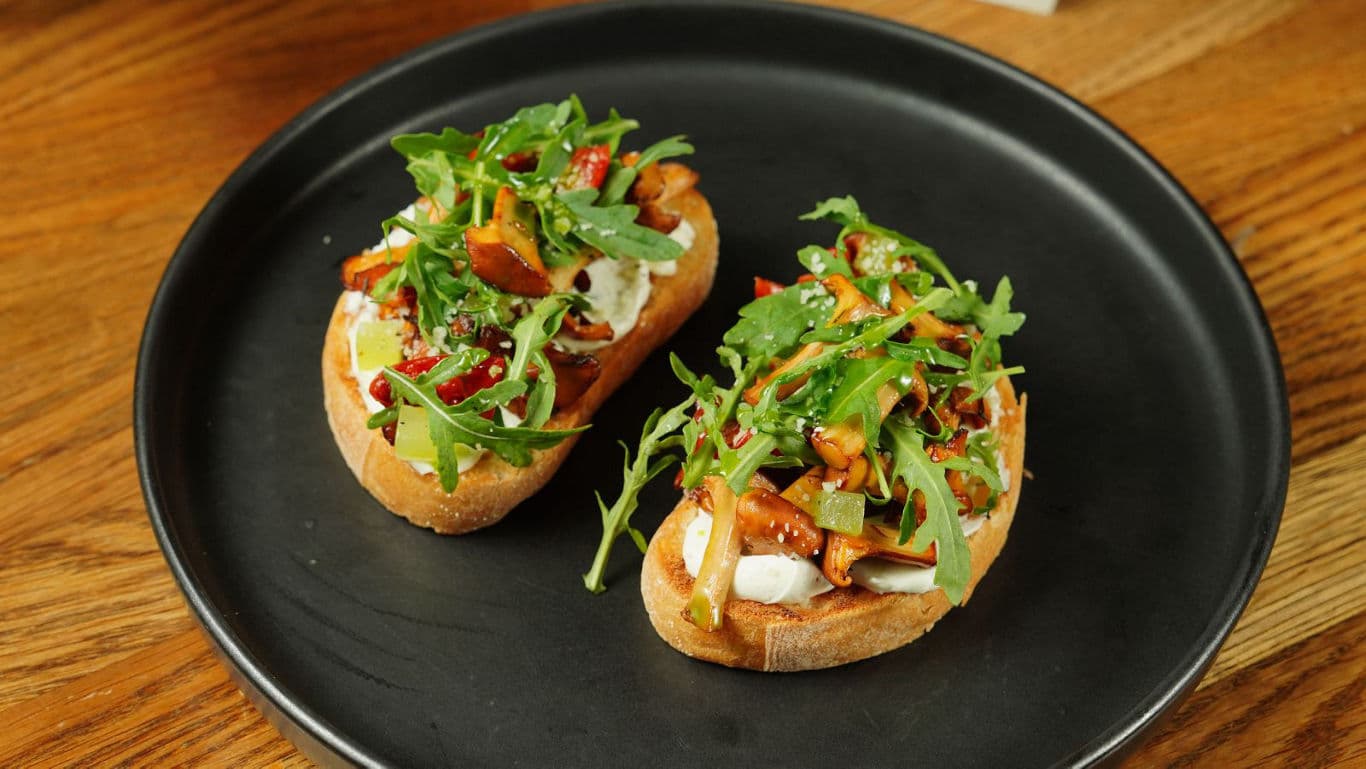 Gourmet bruschetta with arugula and mushrooms