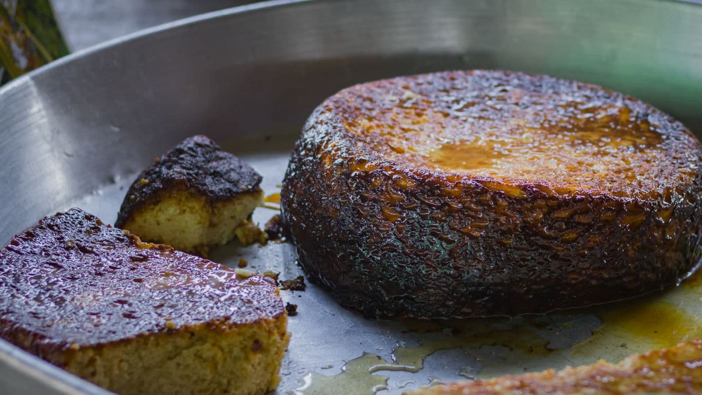 Caramelized flan dessert in metal pan