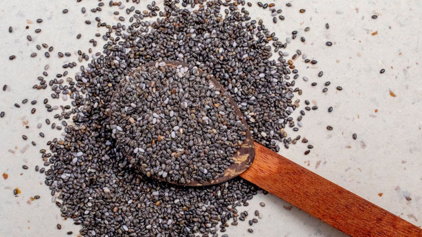 Wooden spoon with chia seeds spilled
