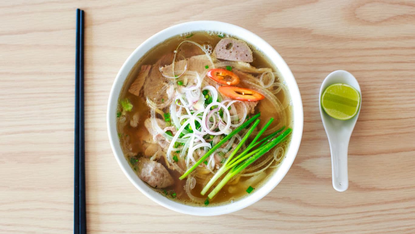 Bowl of Vietnamese Pho with Garnishes