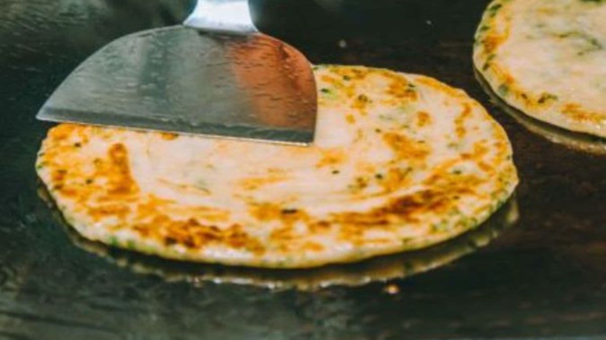 person cooking paratha