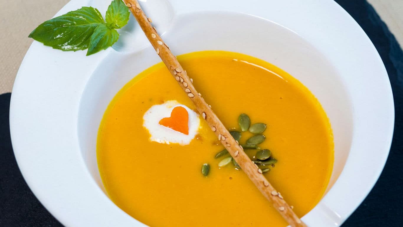 Gourmet pumpkin soup with breadstick garnish