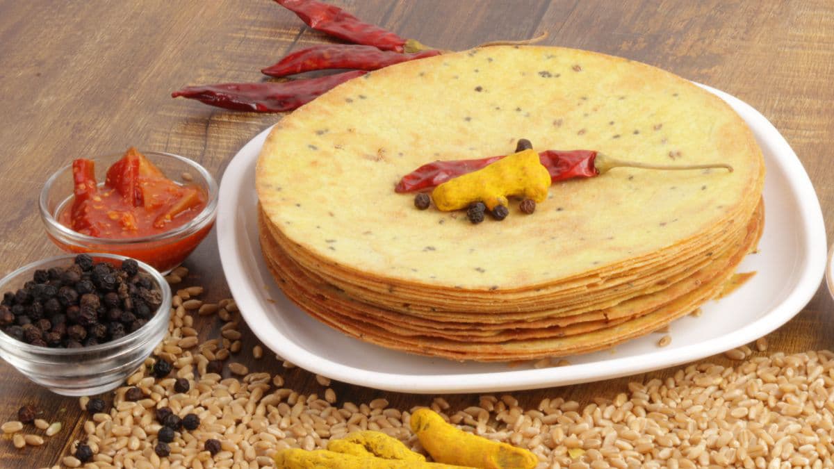 Stack of khapli atta Khakra with red chilli on top
