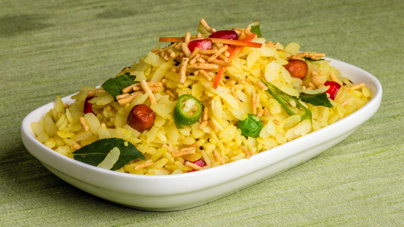 Traditional Indian Poha Dish on Green Background