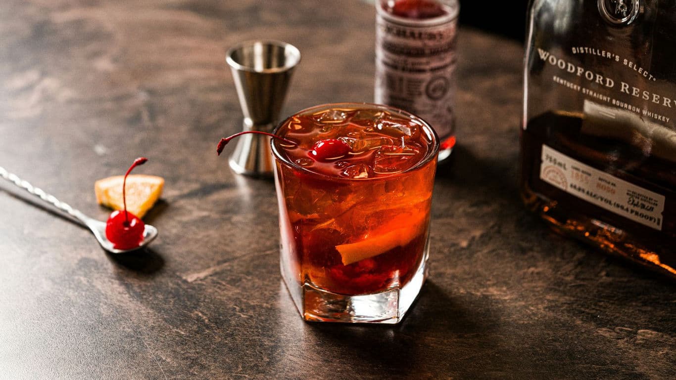 Classic whiskey cocktail with cherry garnish