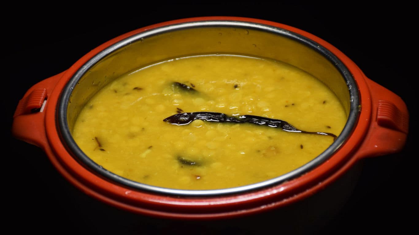 Traditional Indian Dal Tadka in Red Serving Bowl