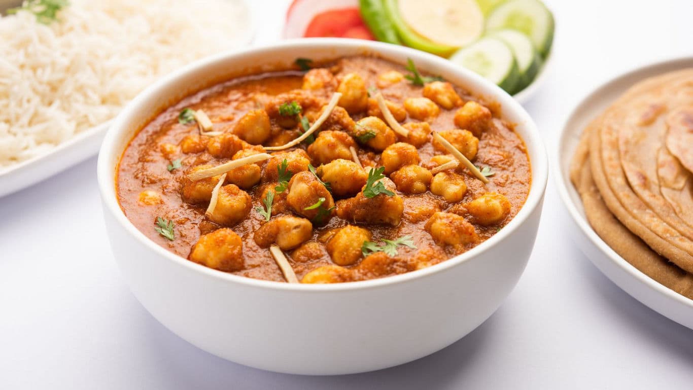 Chickpea curry served with rice and flatbread