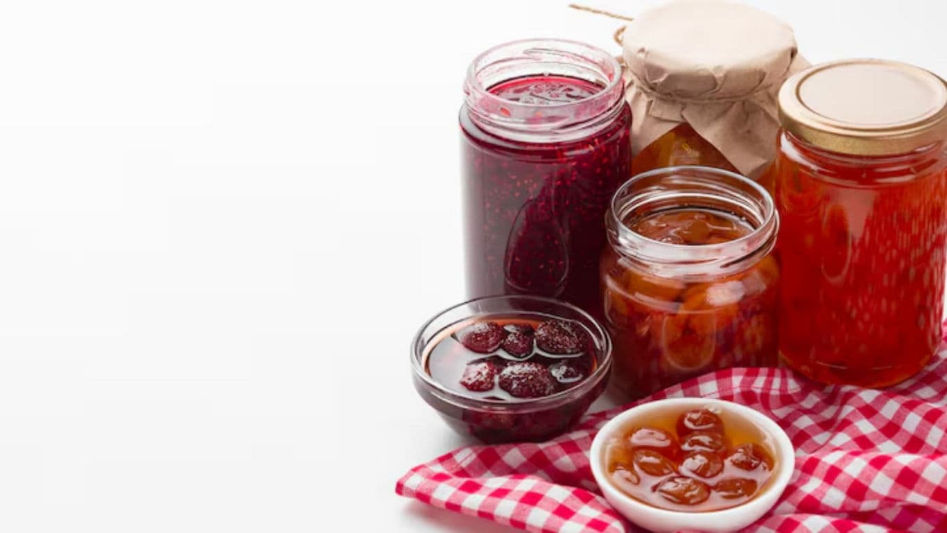 Assorted fruit preserves in glass jars and bowls