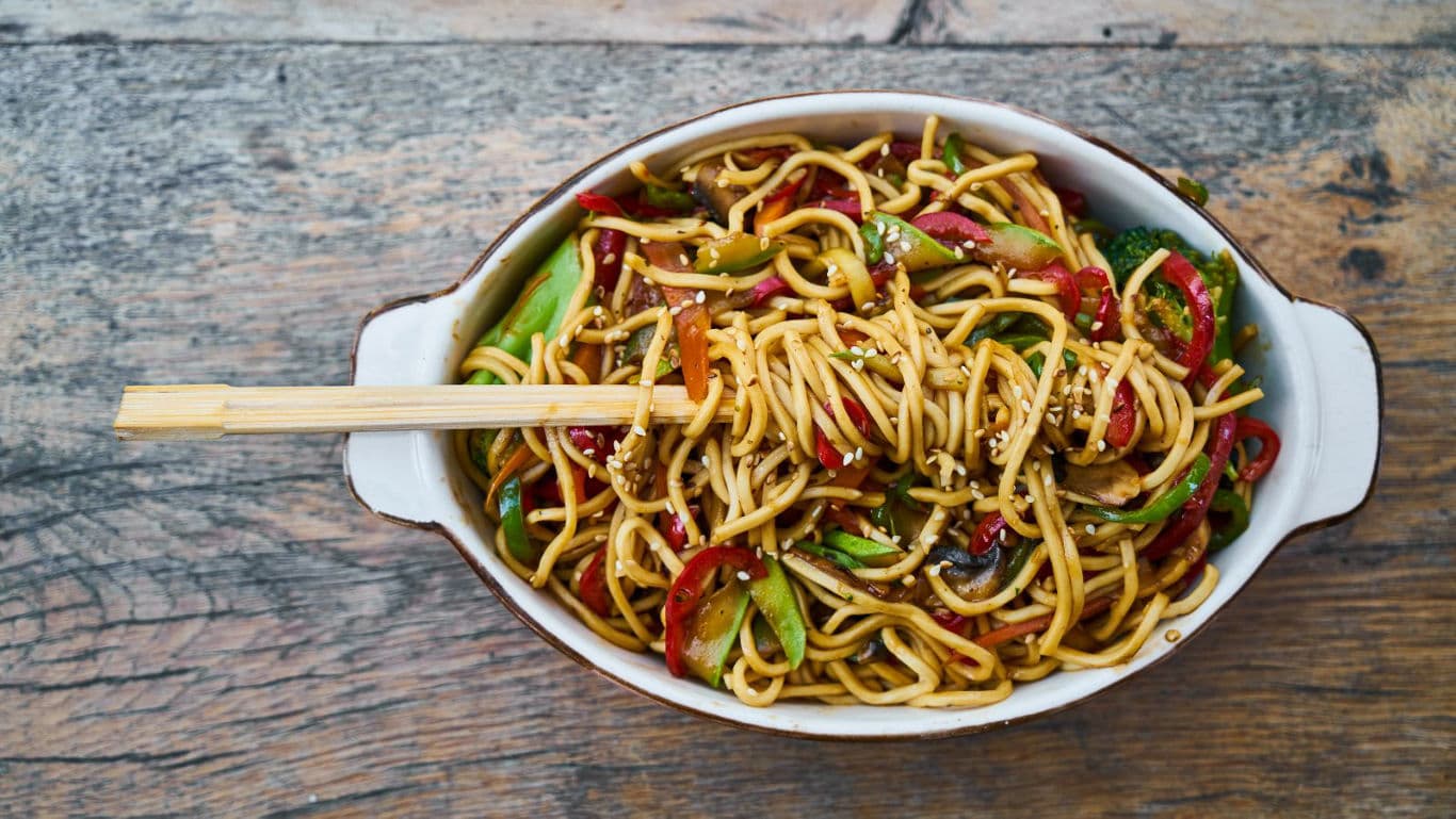 Stir-fried vegetable noodles in ceramic bowl