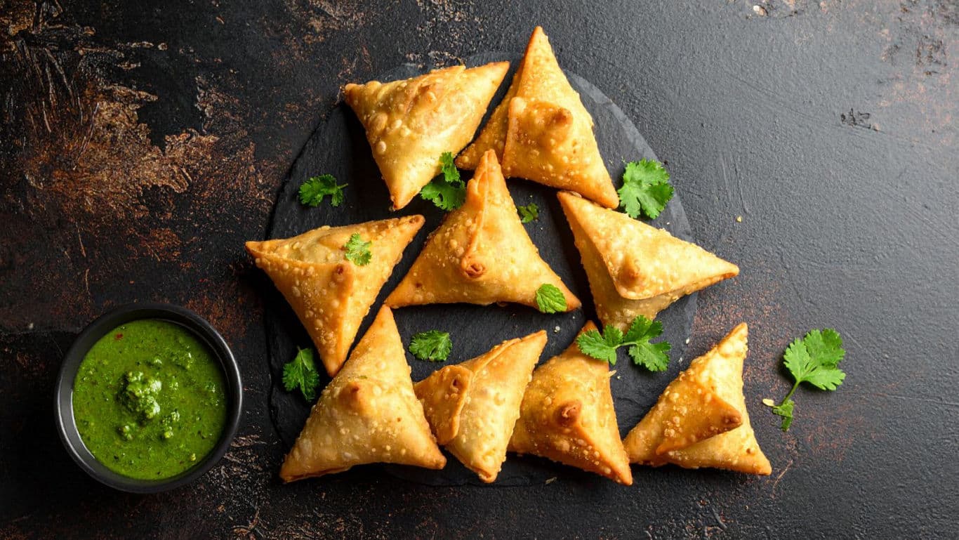 Crispy Samosas with Green Chutney on Slate Plate