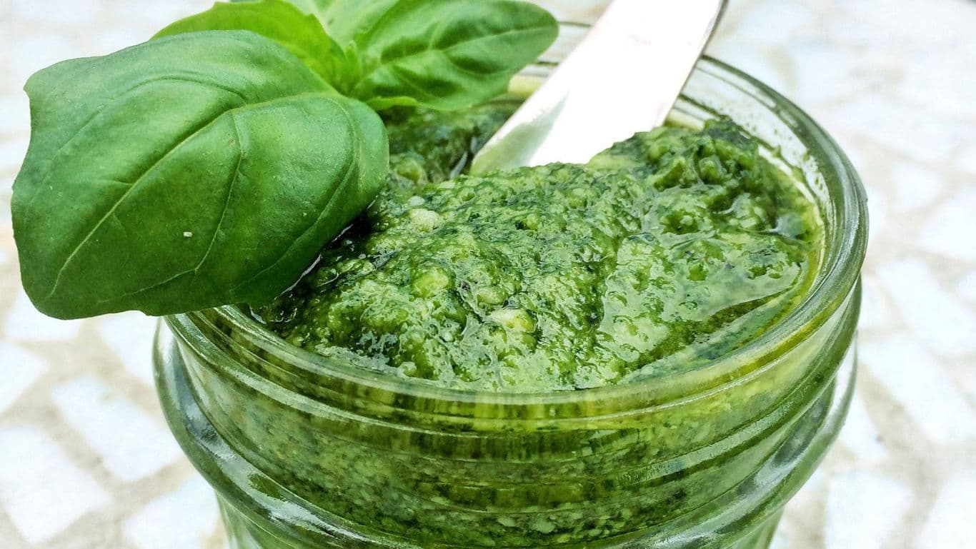 Fresh Basil Pesto in Glass Jar with Spoon