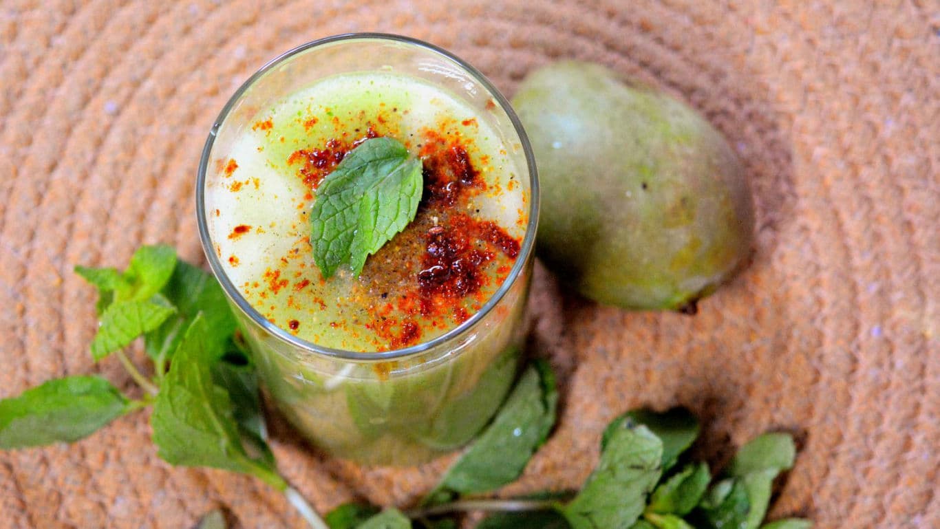 Chilled spiced mango drink with mint garnish