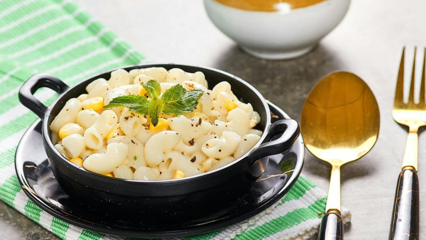 Creamy macaroni pasta served in black bowl