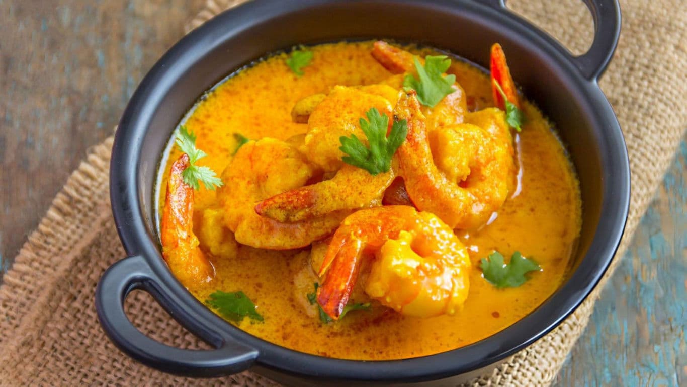 Shrimp Curry in Black Bowl with Fresh Herbs