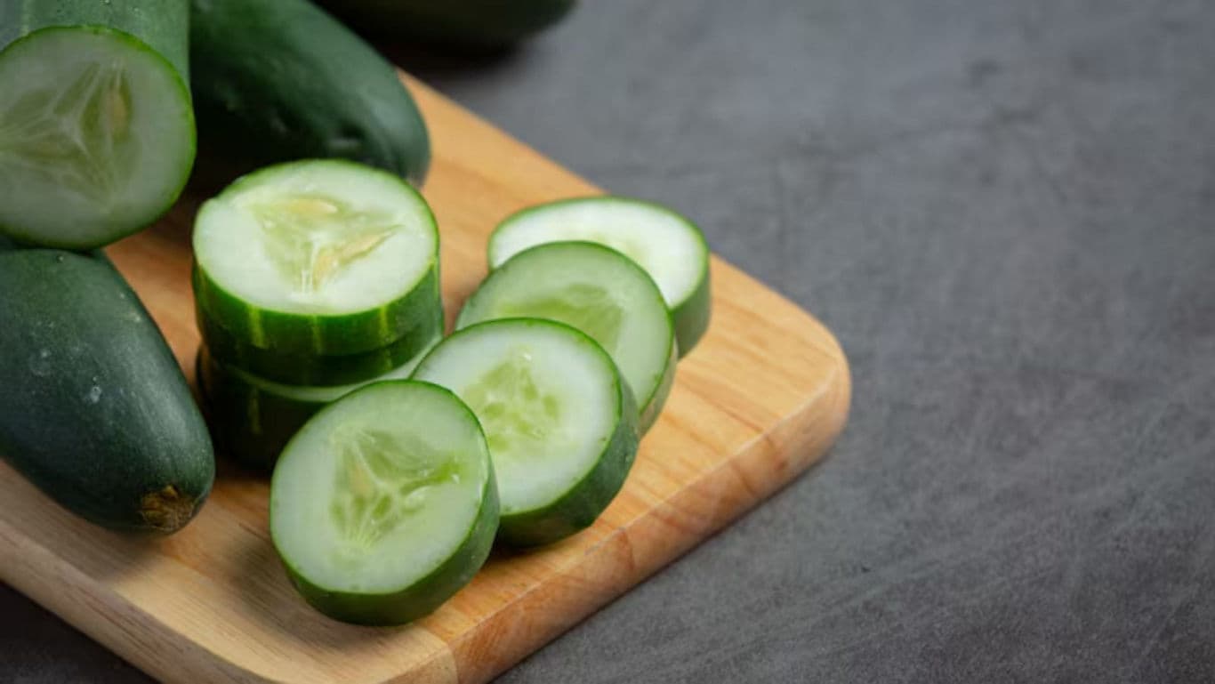 Fresh Sliced Cucumbers on Wooden Cutting Board