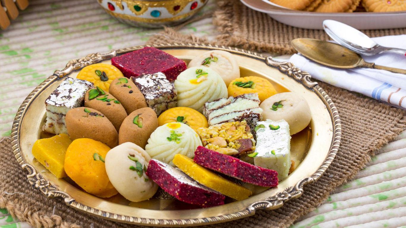 Assorted Indian sweets on golden platter