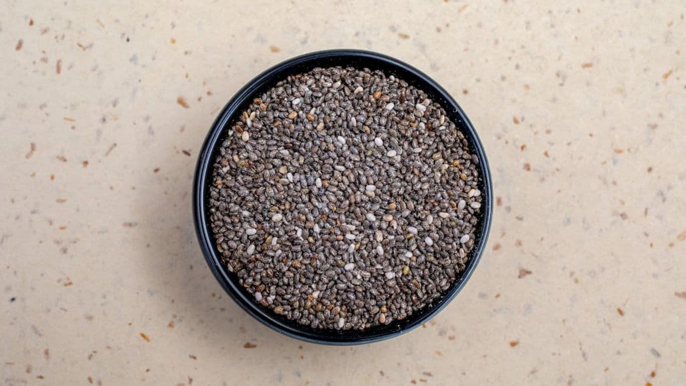Black chia seeds in a round bowl