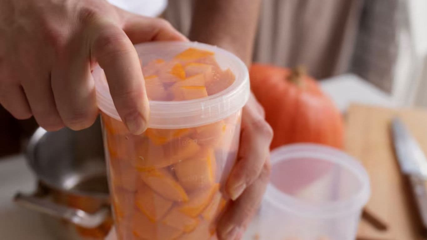 Hand Sealing Container of Fresh Pumpkin Cubes