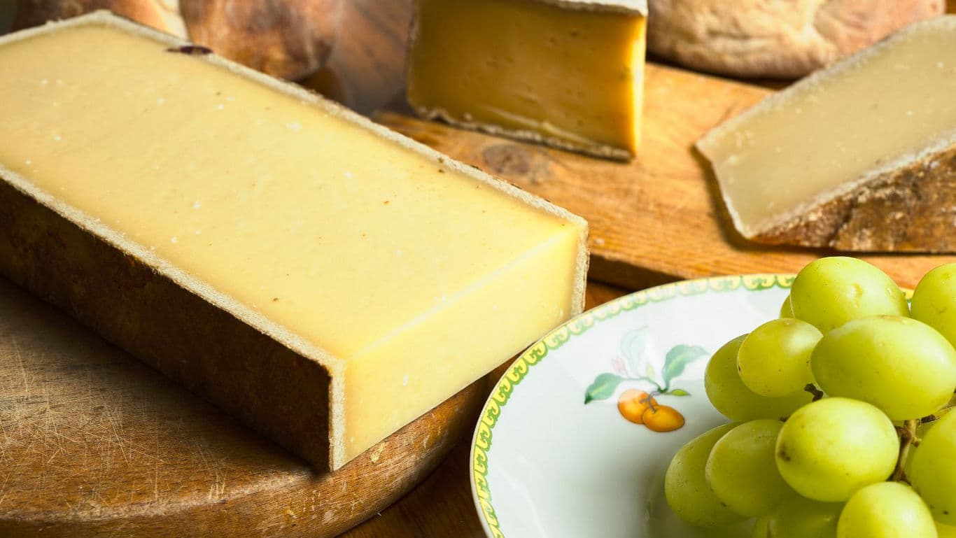 Rustic cheese platter with fresh green grapes