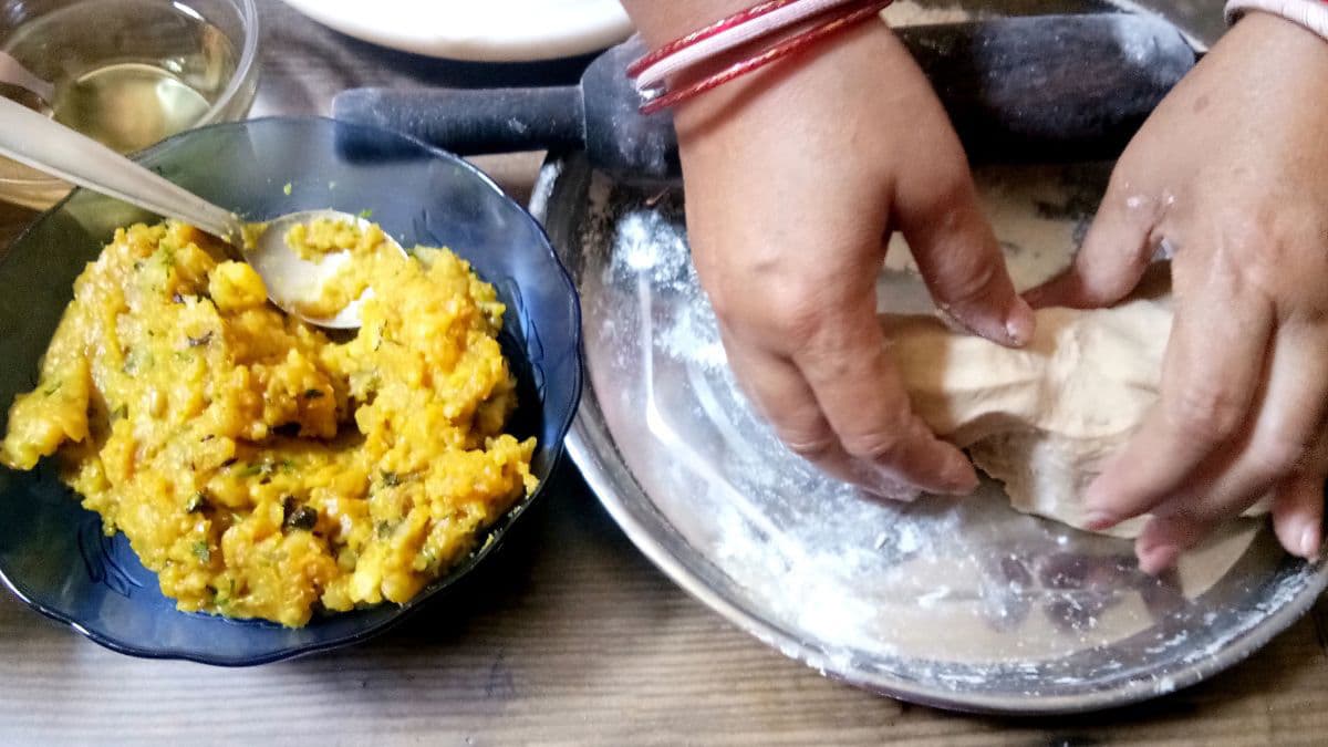 person making and stuffing parathas