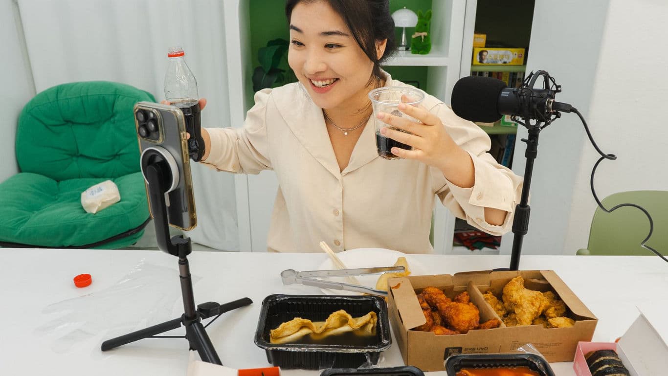 Young woman livestreams fried chicken mukbang