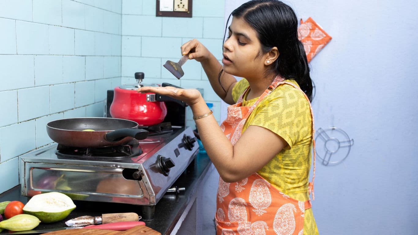Woman preparing spices in home kitchen setting