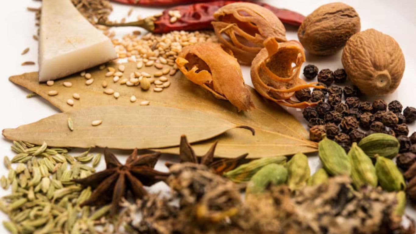 Assorted spices and herbs on white plate
