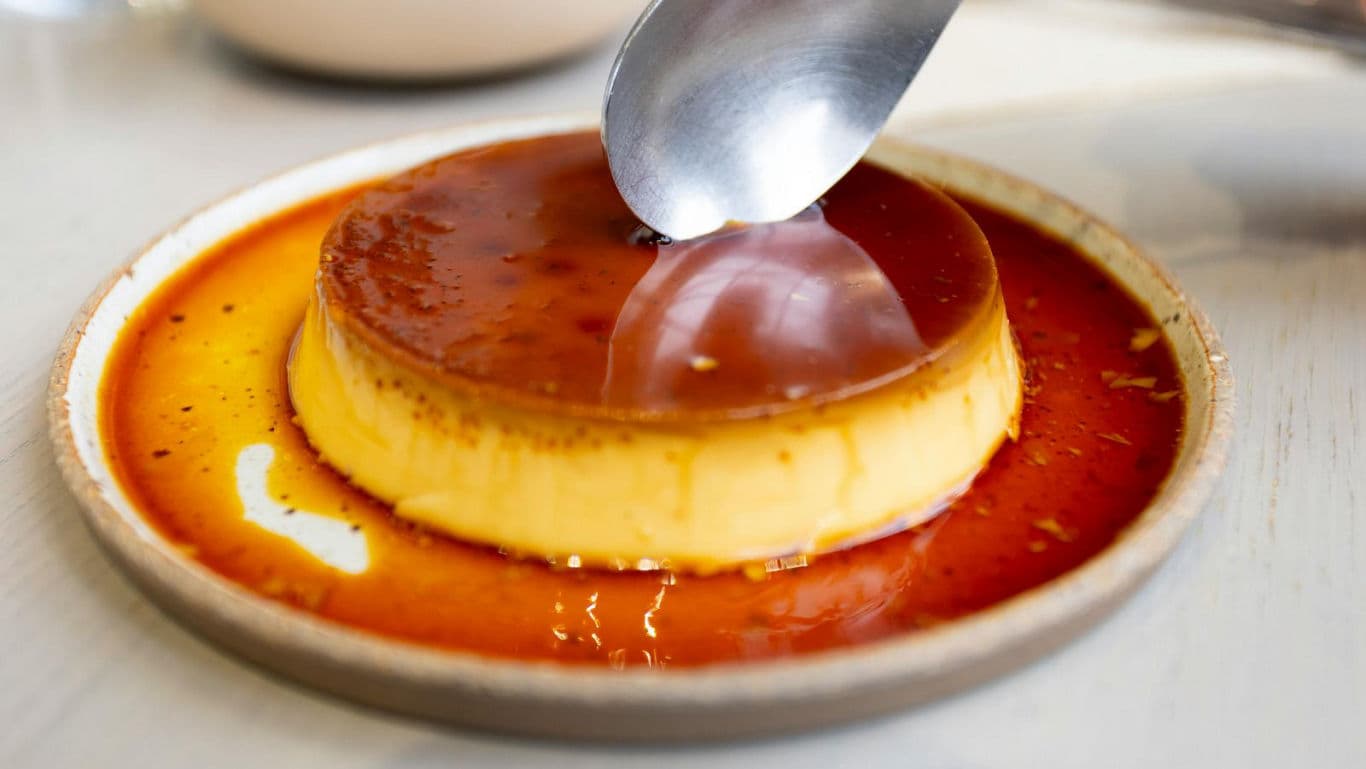 Caramel flan dessert with spoon