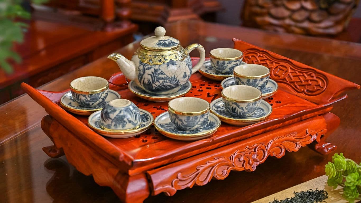 Elegant porcelain tea set on carved tray