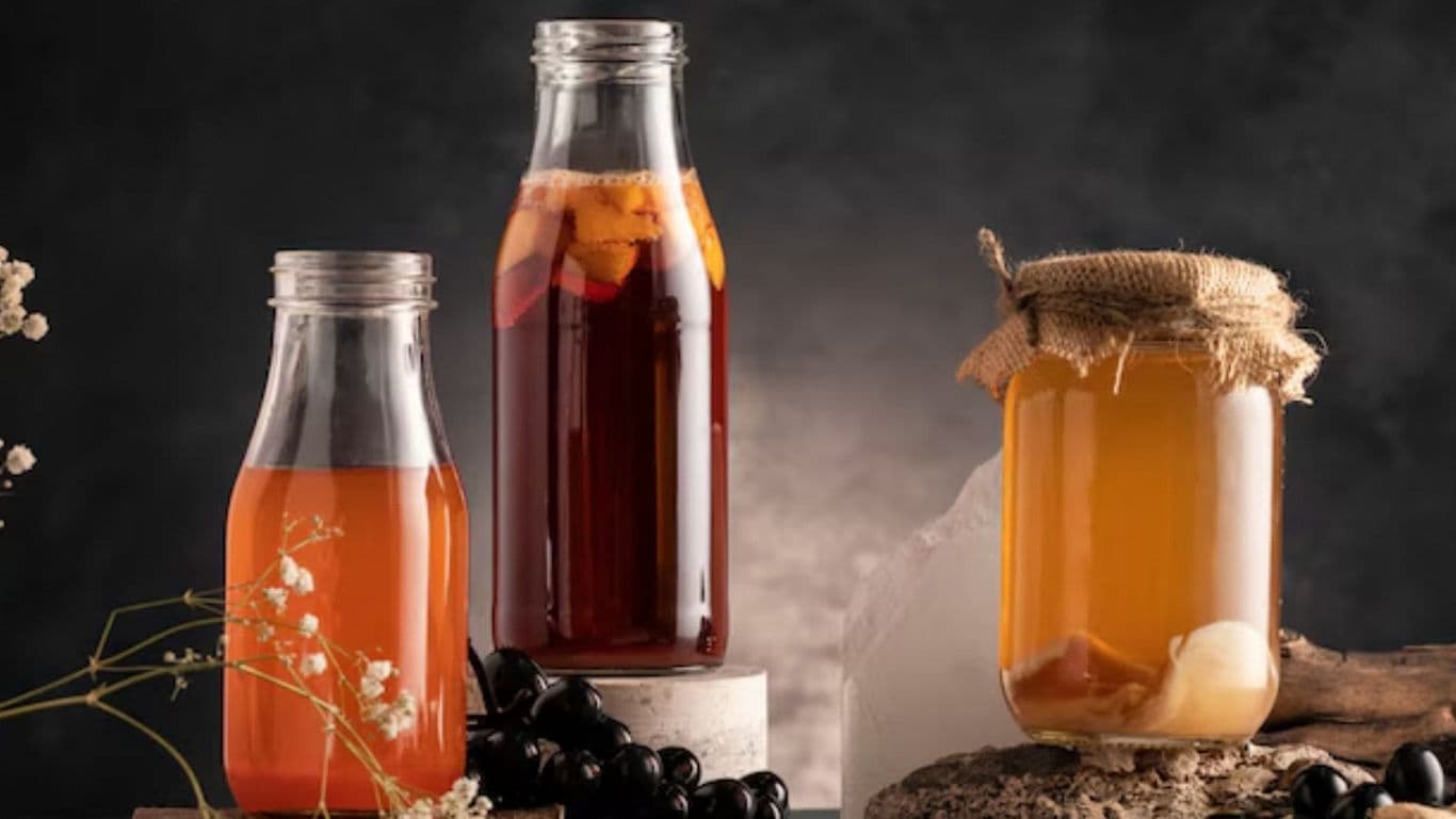 Assorted homemade beverages in glass bottles on rustic table