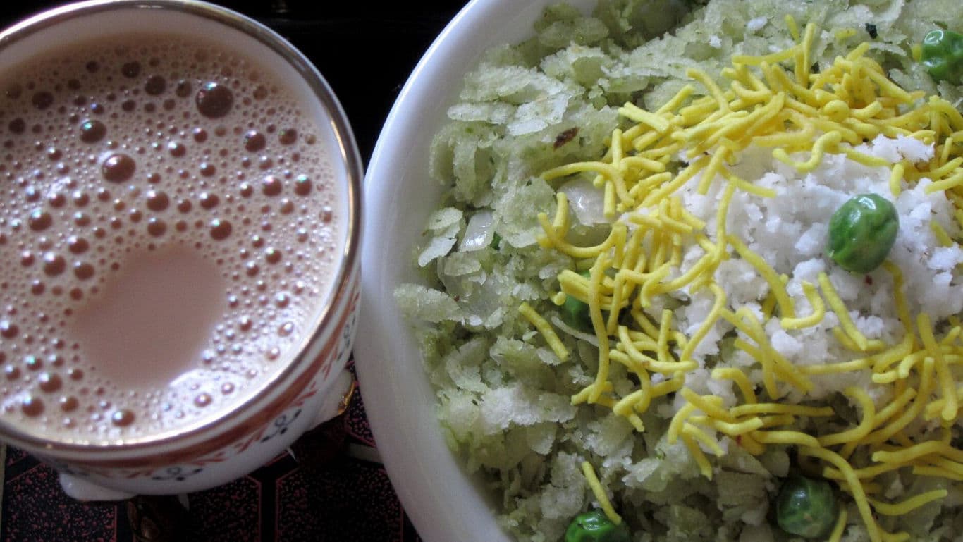 Indian poha breakfast with masala tea