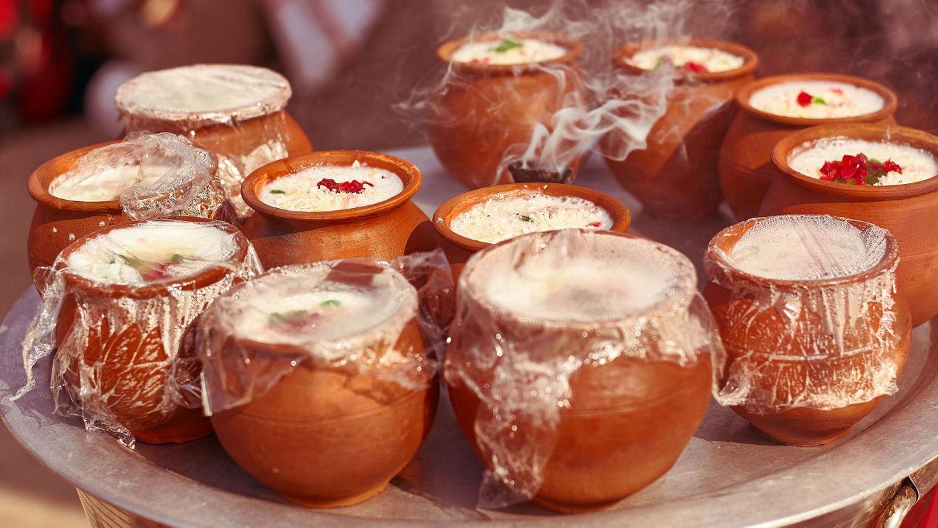 Traditional clay pots with steaming desserts