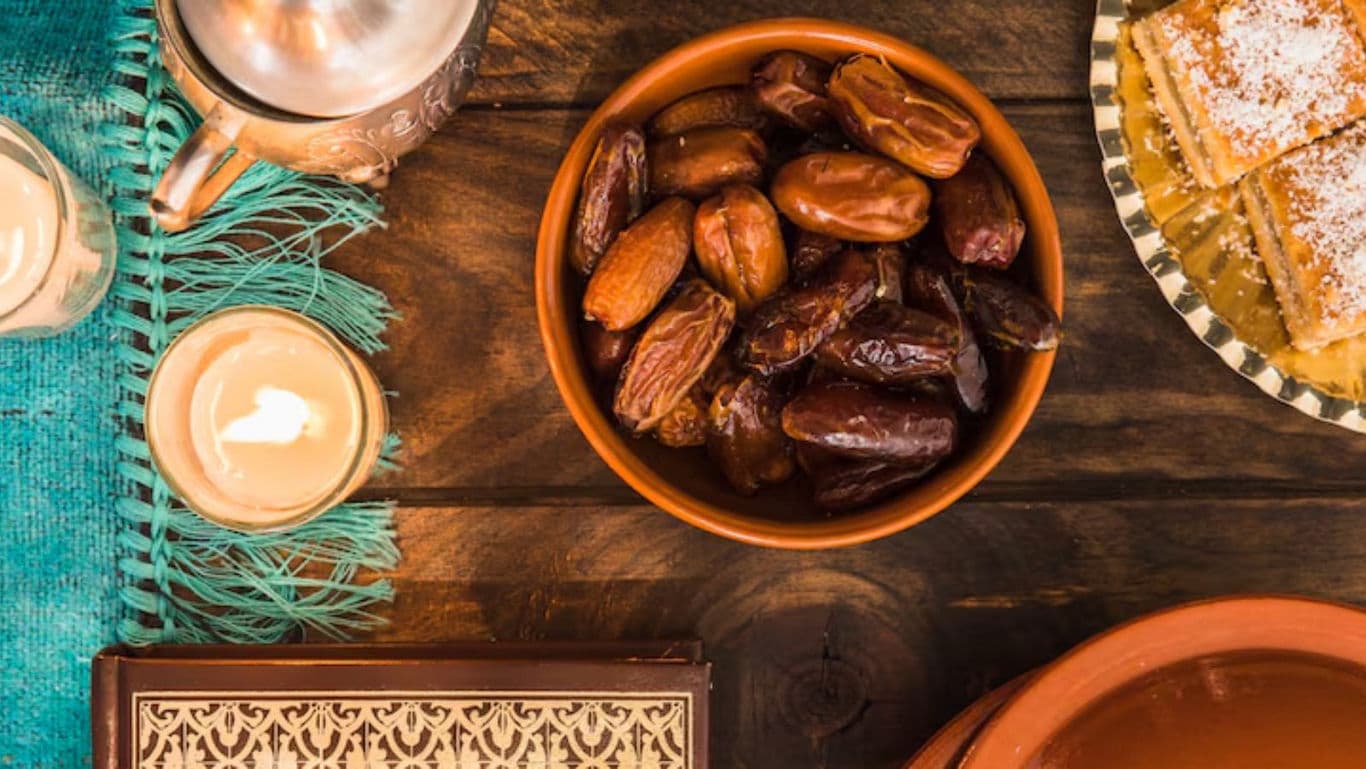 Traditional dates and sweets on rustic wooden table