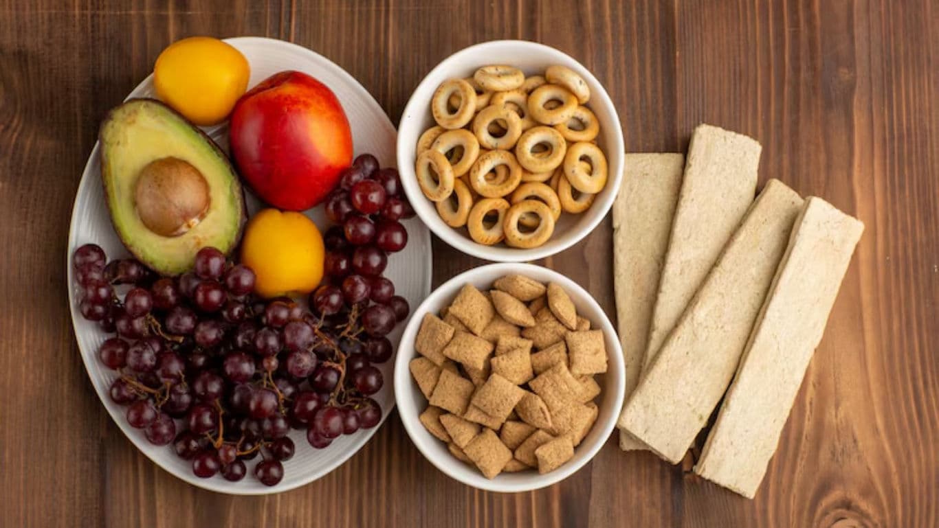 Assorted Fresh Fruits and Dry Snacks on Wooden Table