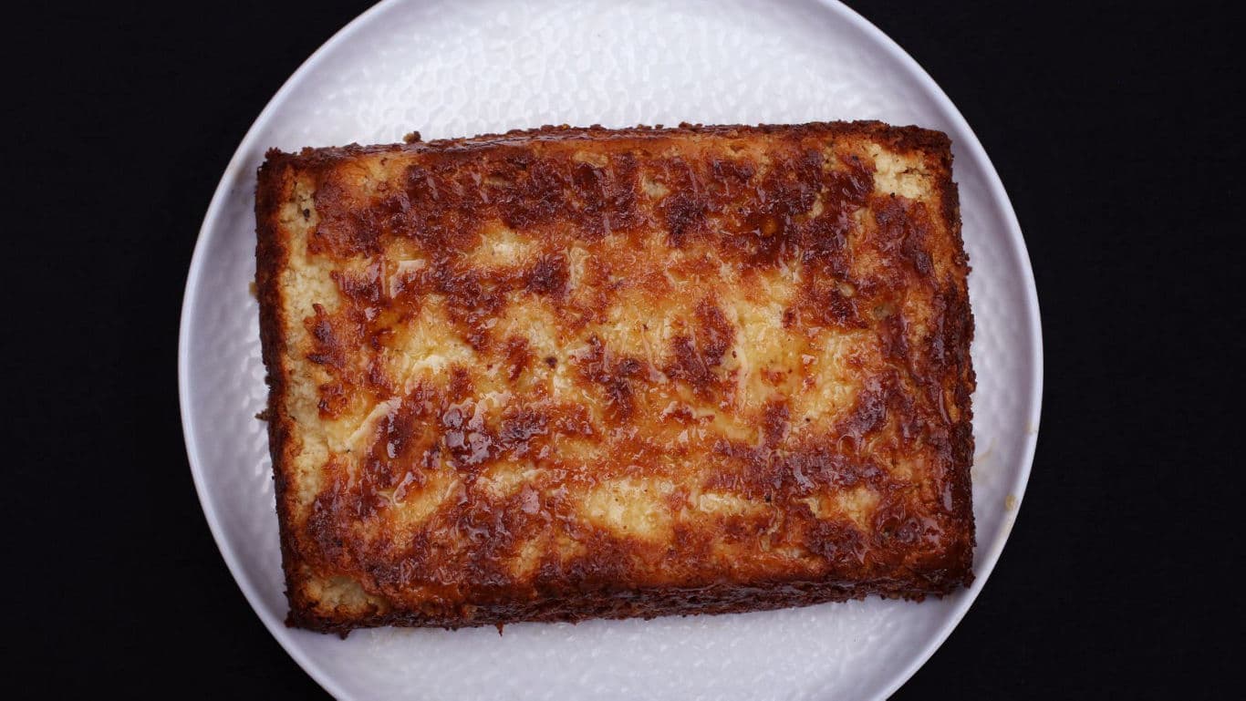 Golden baked rectangular cake on plate