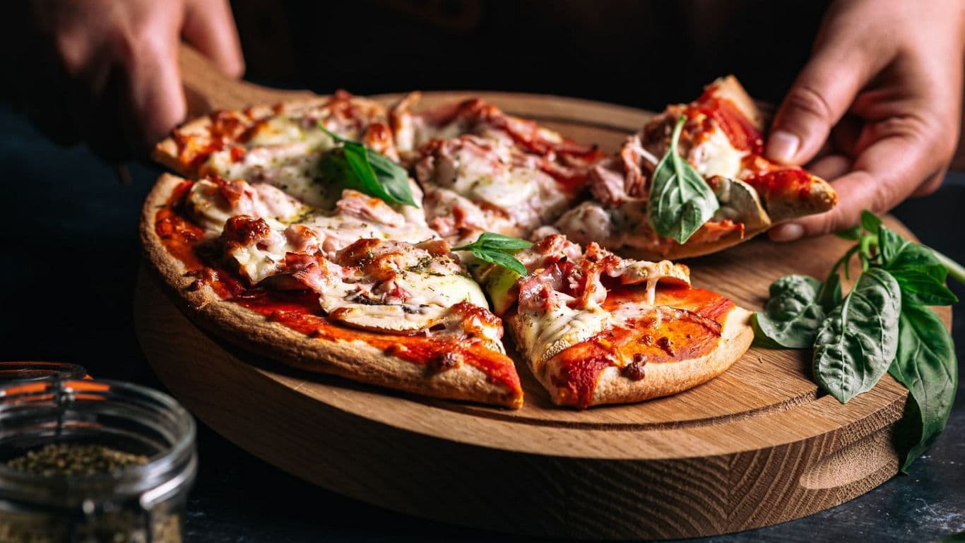 Freshly baked pizza slice being served
