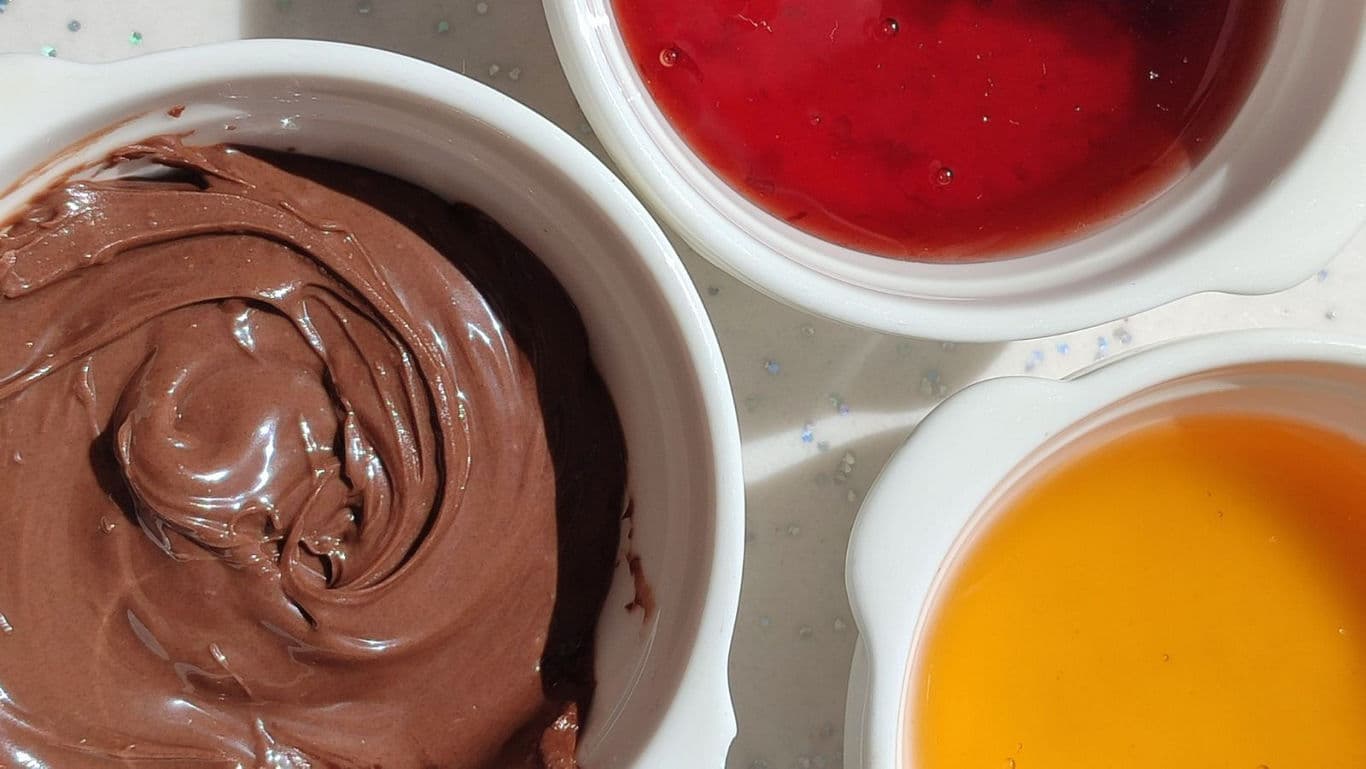 Bowls of chocolate, red and orange sauces