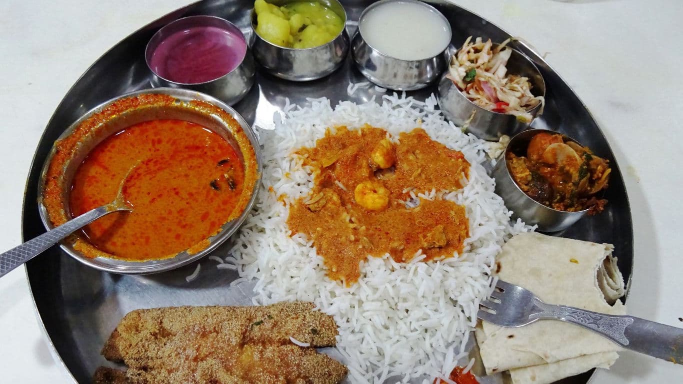 Traditional Indian seafood thali with rice and curry