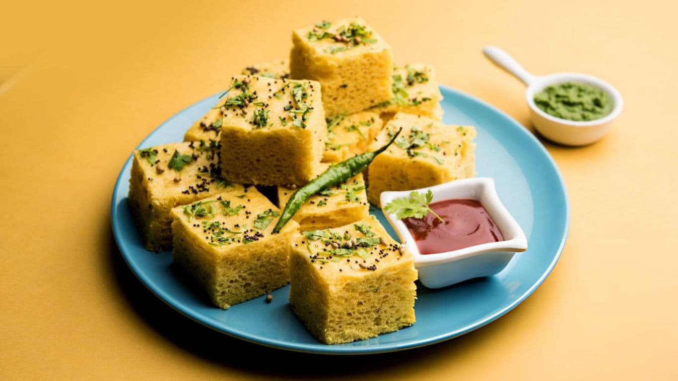 Plate of savory dhokla with chutneys