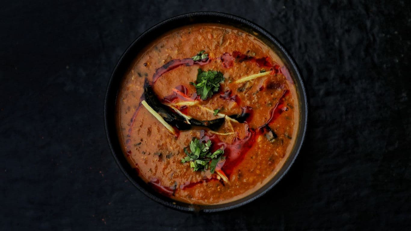 Spiced Indian Lentil Curry with Garnish in Bowl