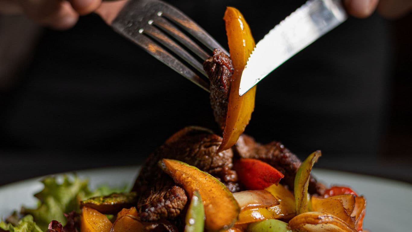 Close-up of fork and knife with stir fry