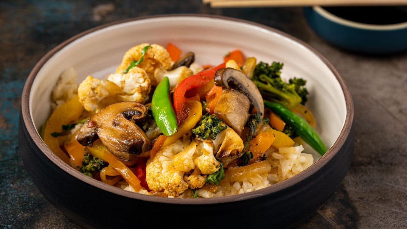 Colorful vegetable stir fry over rice