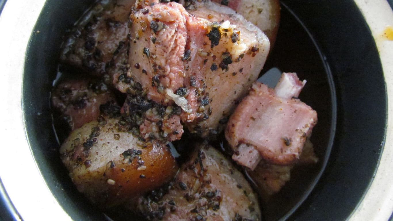 Peppered pork stew in black ceramic bowl